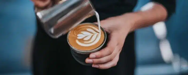 An image of a person pouring coffee