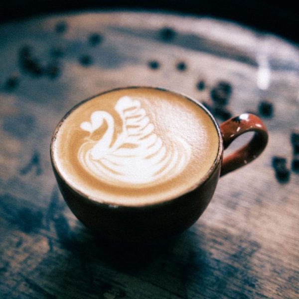 An image of a cup of coffee with a swan pattern on top