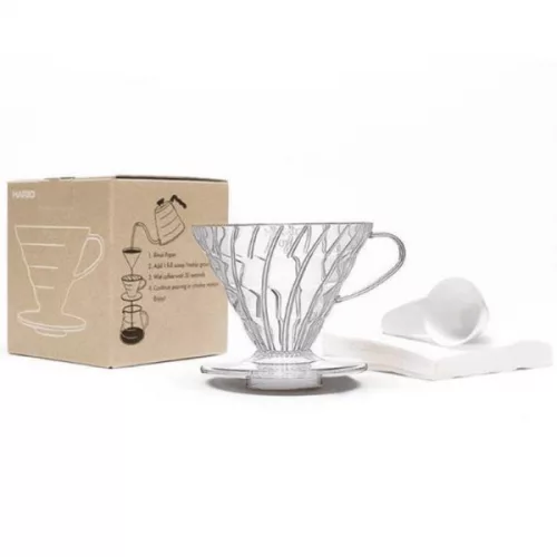 An image of a glass cup on a table with a box to the left and tissues to the right
