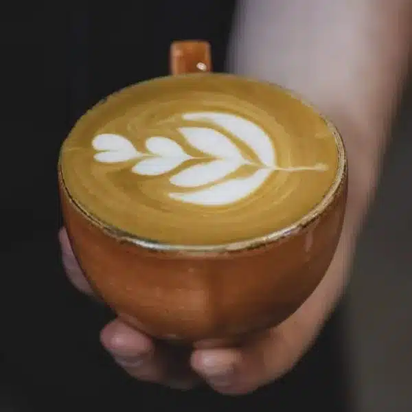 An image of a hand holding a coffee cup
