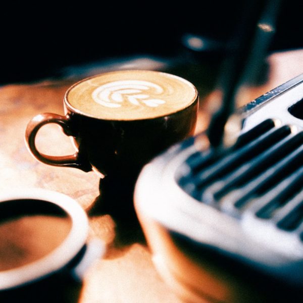 An image of a sage barista express with a cup of coffee in front