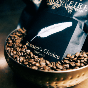 A bag of Iron & Fire's Roaster's Choice coffee, available by a subscription, sat in a bowl of coffee beans.