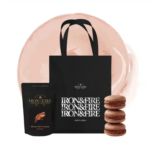 A bag of Mama New Guinea speciality coffee, a black tote bag with the Iron & Fire logo, and three coffee-flavoured macarons. The perfect Mother's Day gift for a coffee loving mum.