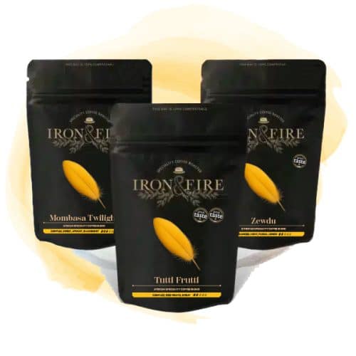 3 black coffee bags in a trio with yellow feather labels on